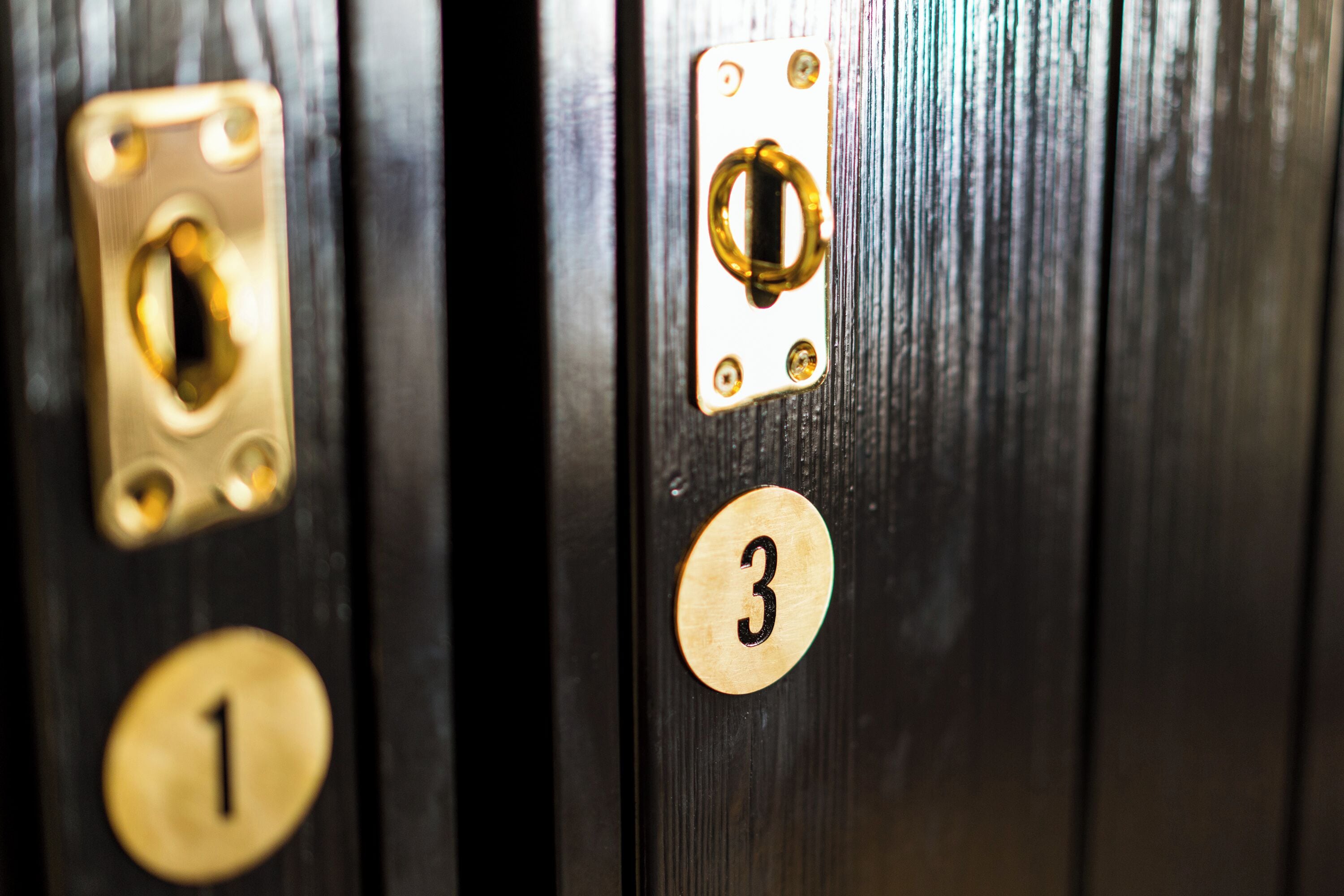A close-up of a door with numbered locks, indicating a secure entry system.