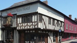 The Cross Keys Hotel with a traditional Tudor-style facade, featuring exposed timber framing and a prominent sign above the entrance. - The Cross Keys (Saffron Walden)