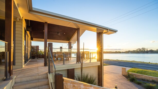 A covered outdoor area with steps leading to a deck overlooking a body of water. - Ana Mandara Luxury Retreat (Port Macquarie)