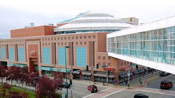 A large building with a distinctive dome and a modern glass extension.
