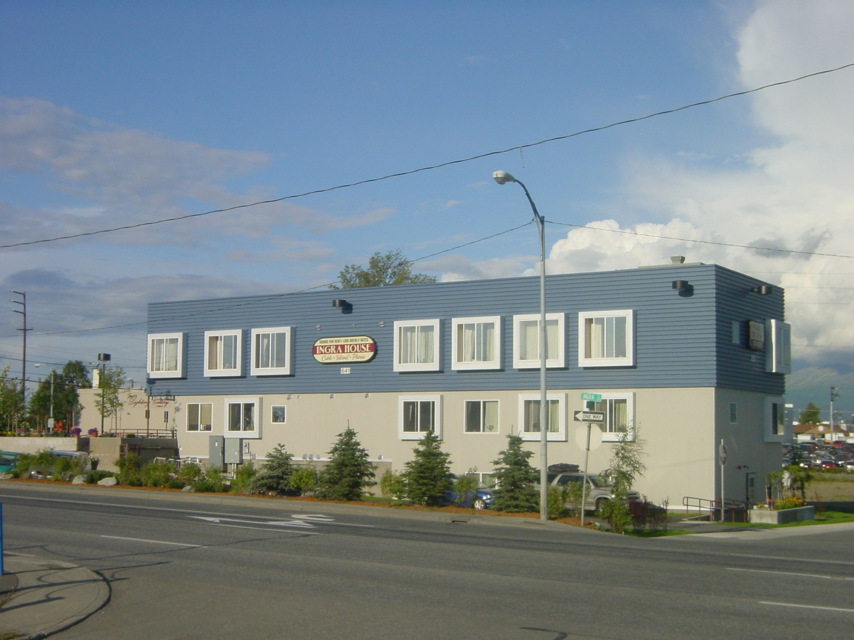 A two-story building with a sign that reads "INGRA HOUSE."
