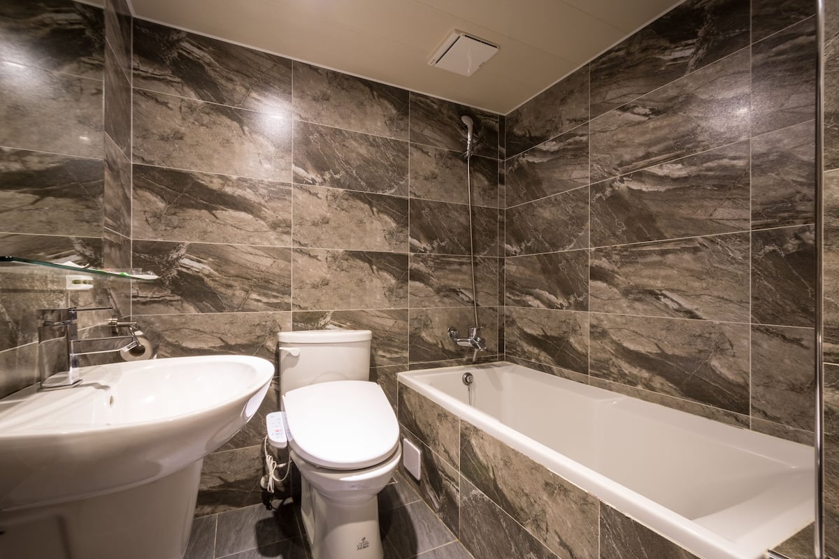 Standaard tweepersoonskamer | Badkamer | Een bad/douchecombinatie, gratis toiletartikelen, een haardroger