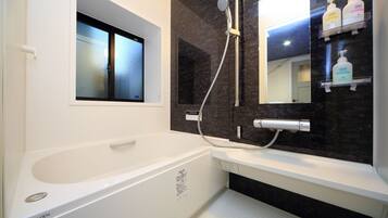 Combined shower/tub, free toiletries, hair dryer, slippers