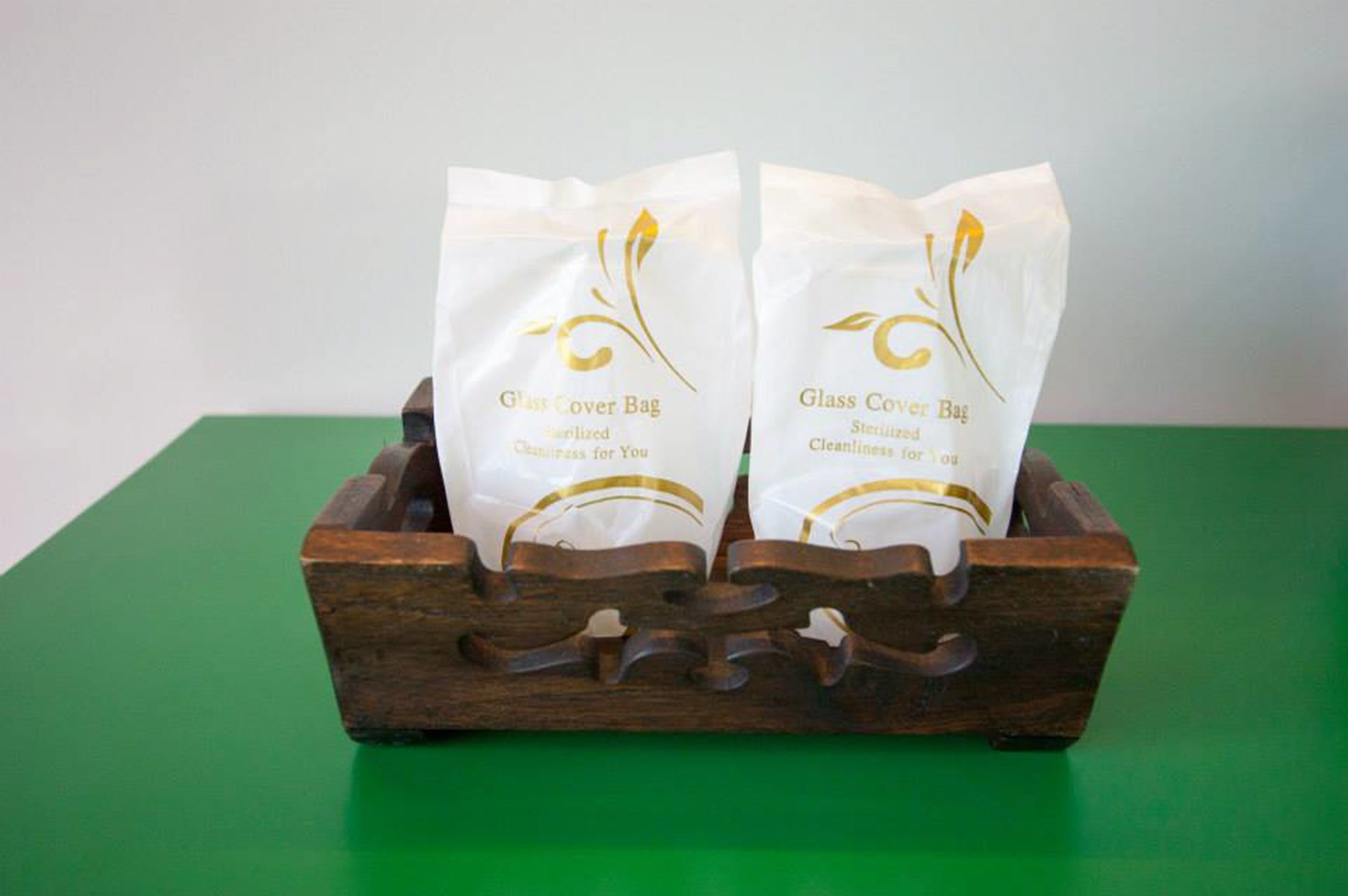 Two glass cover bags in a wooden box.