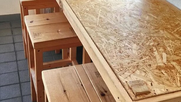 A long wooden table with benches in a room with a window. - BaseInn Komagome Tokyo - Hostel (Tokyo)