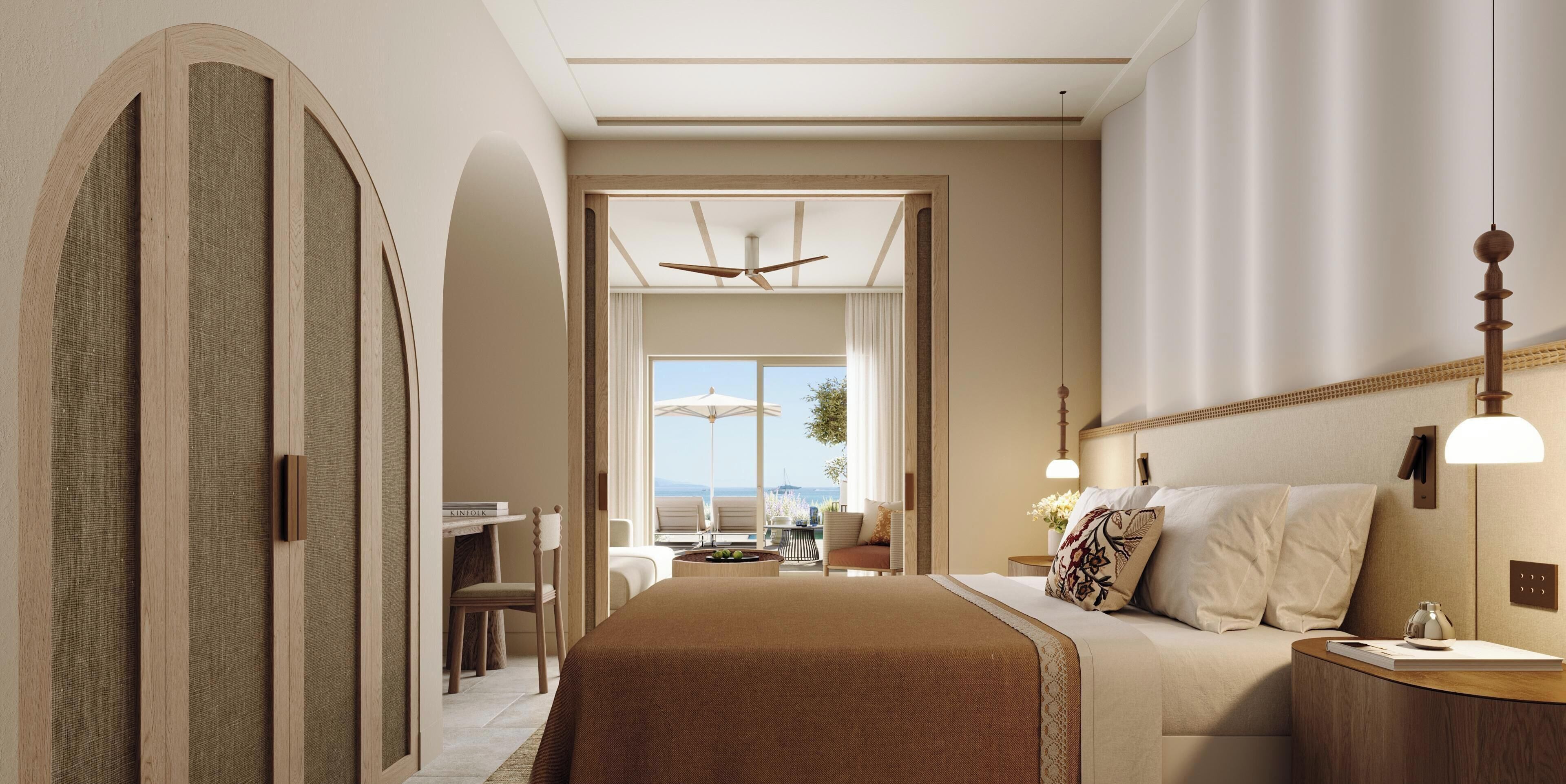 Una habitación de hotel con una cama grande, un escritorio y vistas al exterior.
