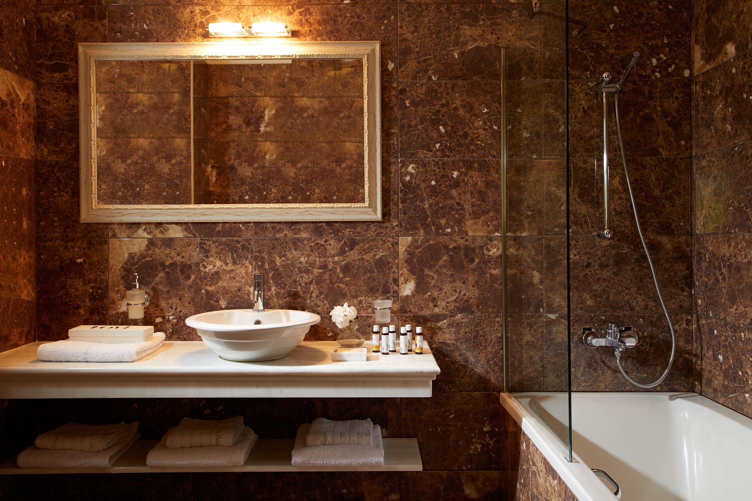 designer toiletries, hair dryer, slippers, towels