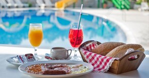 A breakfast setting with a pool in the background.