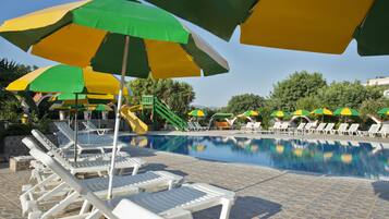 Relax by the pool with comfortable lounge chairs and umbrellas.