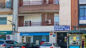 A multi-story building with a sign reading "Hostal Gran Via". - Hostal Gran Vía (Pinto)