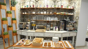 A breakfast buffet with various food items and a coffee station. - Hostal Gran Vía (Pinto)