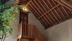 A rustic stone building with a wooden staircase leading to a balcony. - La Cuvellerie (Narcy)