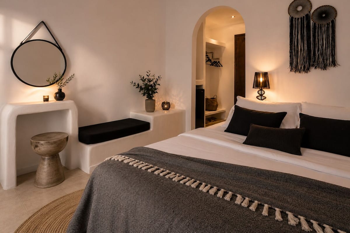 A modern bedroom with a bed, bedside tables, a mirror, and a lamp.
