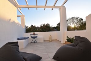 Triple Room, Garden View, Ground Floor | Balcony view - Aegeeis (Santorini)