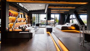 A modern interior with a sofa, a coffee table, and a bookshelf.