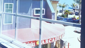 A view through a window of a building with a sign for 'Arcade Arcade'. - Capitola Hotel (Capitola)
