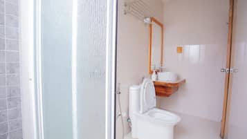 A bathroom with a toilet, a sink, and a shower.