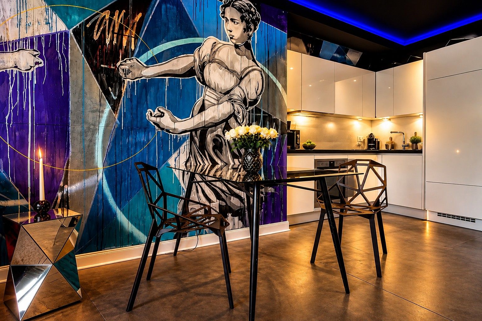 A modern kitchen with white cabinets, a dining table with chairs, and a decorative wall with a mural.
