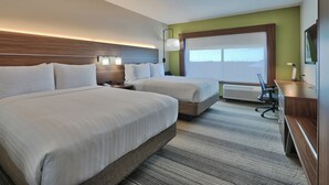 A hotel room with two beds, a desk, a chair, and a large window. - Holiday Inn Express & Suites Houston East - Beltway 8 by IHG (Houston)