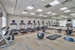 A gym with treadmills, elliptical machines, and free weights. - Holiday Inn Express & Suites Houston East - Beltway 8 by IHG (Houston)