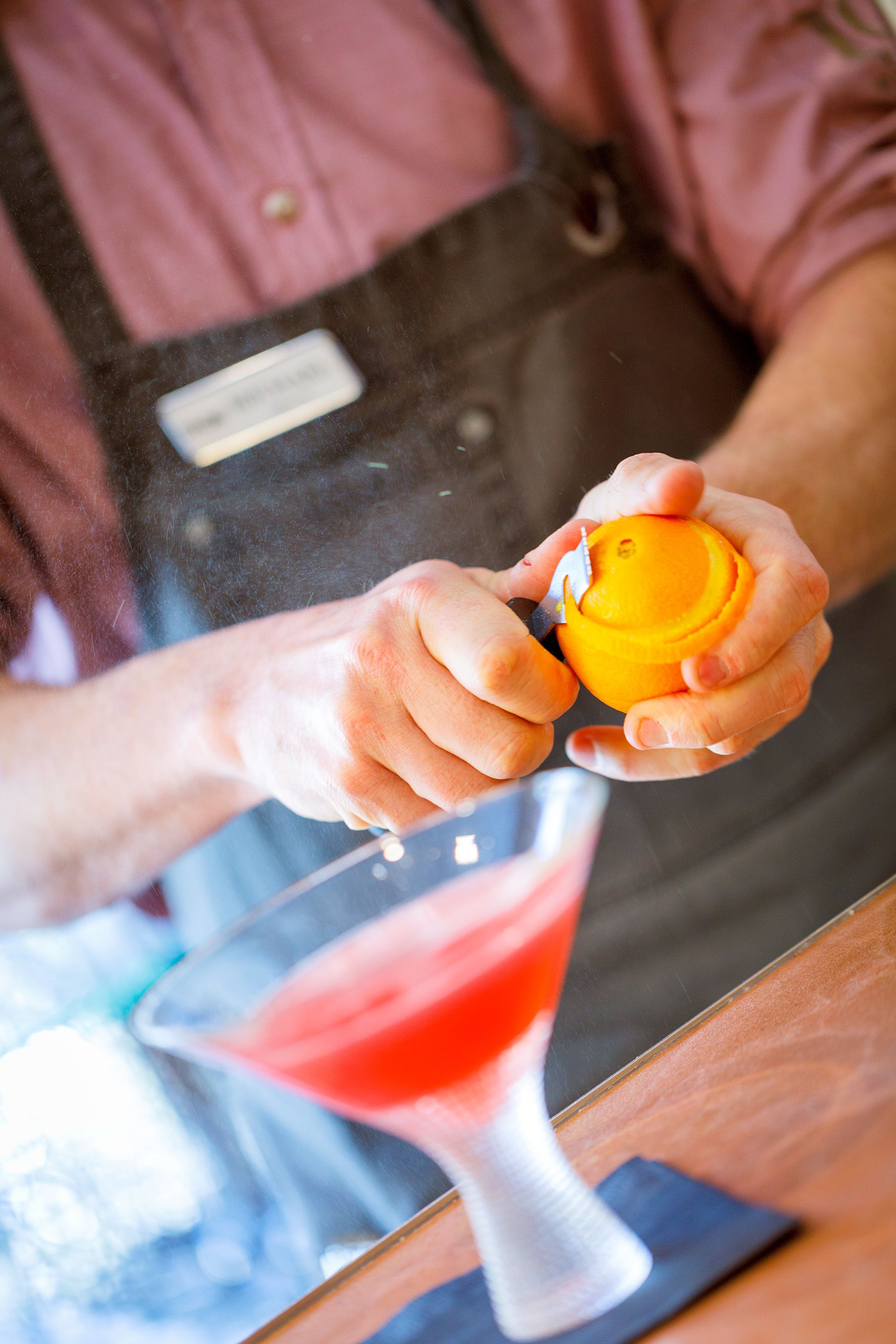 A person squeezing an orange.