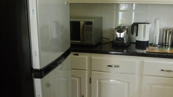 Fridge, oven, coffee/tea maker, cookware/dishes/utensils