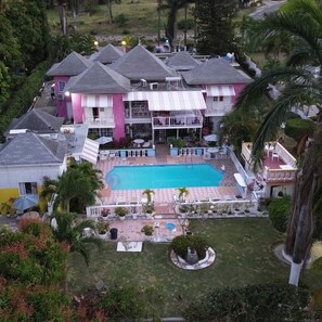 A large house with a swimming pool, multiple balconies, and a well-maintained garden. - PinkHibiscus Guest House (Montego Bay)