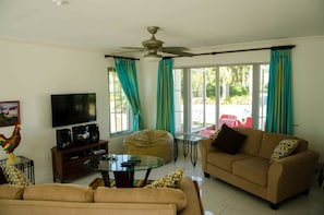 Deluxe Condo, 2 Bedrooms, Kitchen, Beach View | Living room | Flat-screen TV - Seas the Day Sanctuary (Negril)