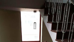 A wooden staircase with metal railings and a small window at the top. - Mirim Motel (Gyeongju)