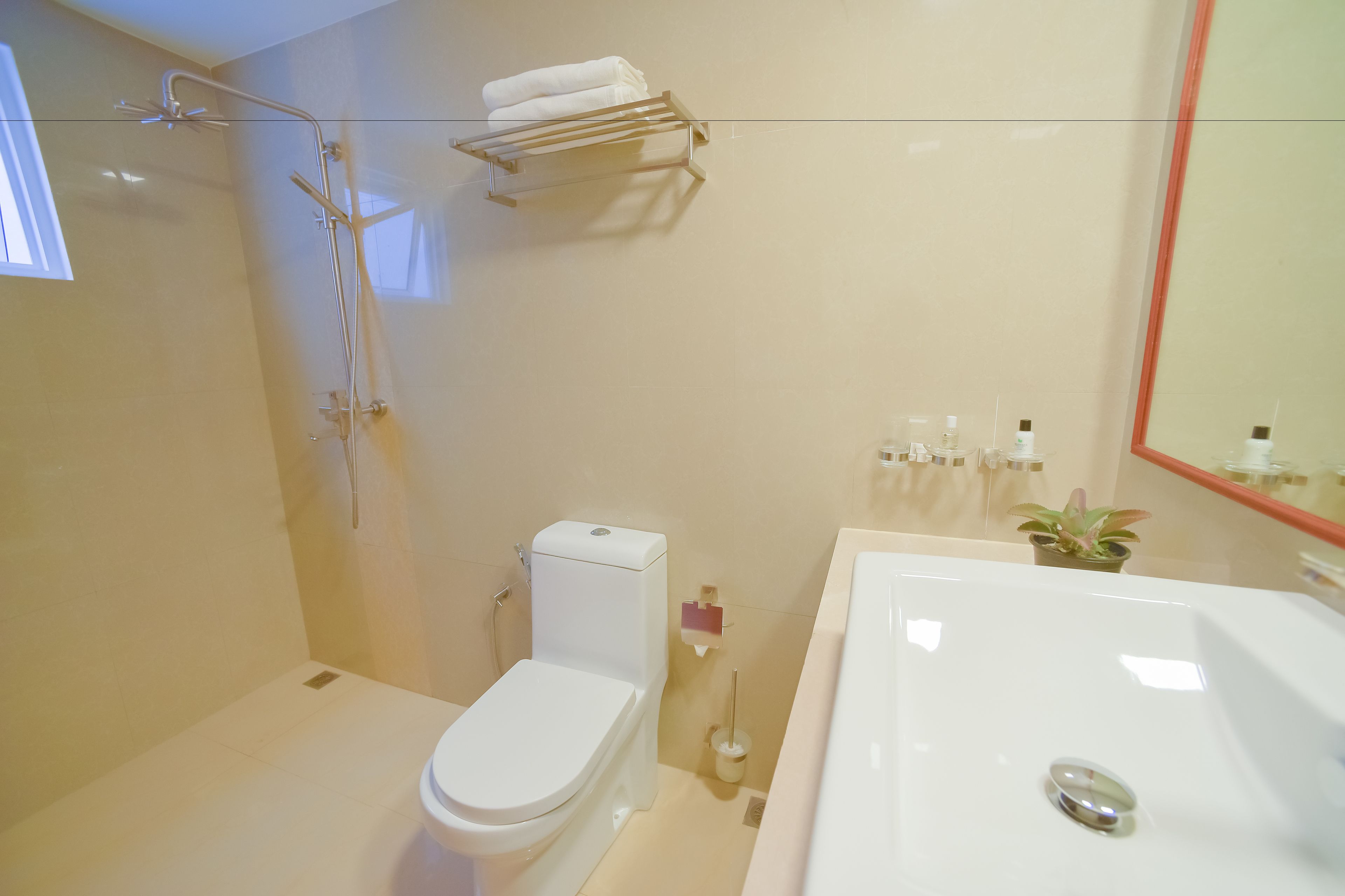 A modern bathroom with a toilet, shower, and bathtub.
