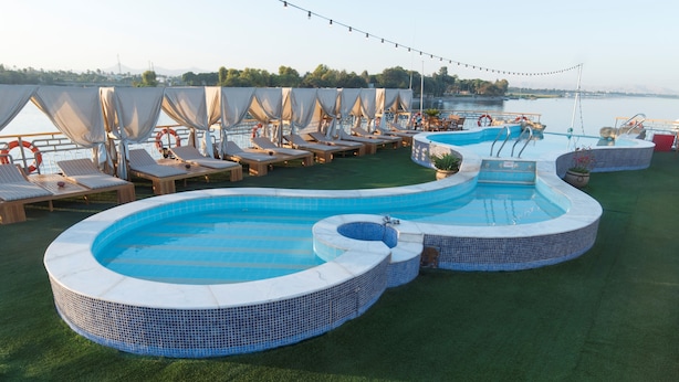 A pool area with multiple lounge chairs and a hot tub. - Sonesta Star Goddess Nile cruise ship - 4 & 7 nights - From Luxor every Saturday (Luxor)