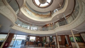 A multi-level atrium with a central skylight, ornate railings, and a view of the sea. - Sonesta Star Goddess Nile cruise ship - 4 & 7 nights - From Luxor every Saturday (Luxor)
