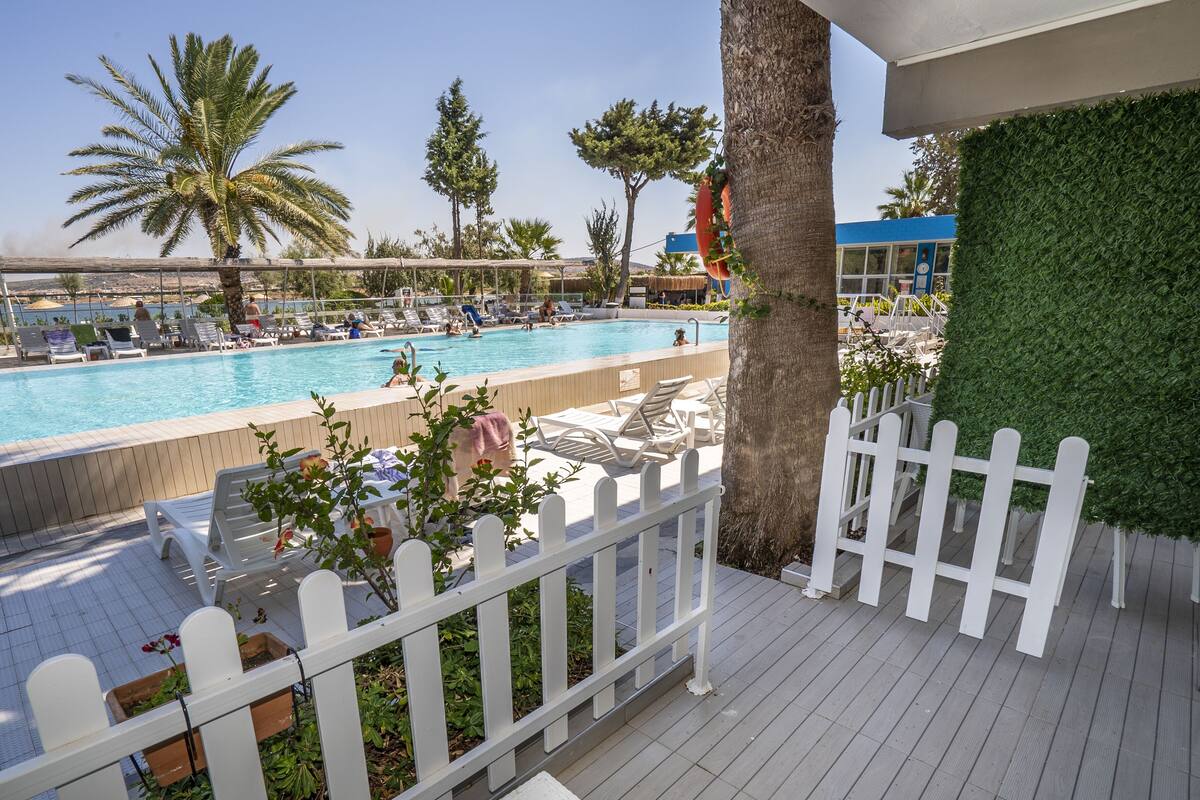 A poolside area with lounge chairs and a view of the pool.