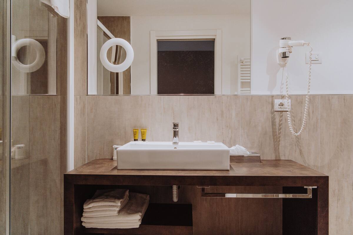 separate bathtub and shower, hair dryer, slippers, bidet