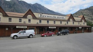 A building with a sign reading 'Reynolds Hotel' and adjacent storefronts labeled 'Liquor Store' and 'Restaurant.' - Reynolds Hotel (Lillooet)