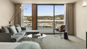 A modern hotel room with a large sliding glass door leading to a balcony with a marina view. - MACq 01 Hotel (Hobart)
