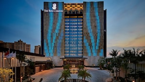 A modern hotel with a prominent entrance and a well-lit facade. - The Ritz-Carlton, Haikou (Haikou)