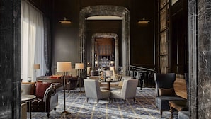A spacious lobby with a grand piano, seating area, and a bar. - The Ritz-Carlton, Haikou (Haikou)
