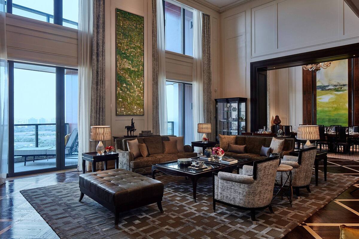 A spacious living room with a large window, a fireplace, and a view of the outdoors.