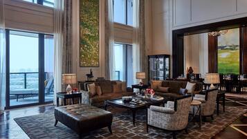 A spacious living room with a large window, a fireplace, and a view of the outdoors.