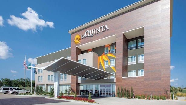 A modern hotel with a prominent 'La Quinta' sign, a covered entrance, and a landscaped front yard. - La Quinta Inn & Suites by Wyndham Tulsa Broken Arrow (Broken Arrow)