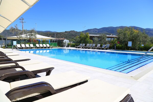 Seasonal outdoor pool, open 8:00 AM to 8:00 PM, pool umbrellas