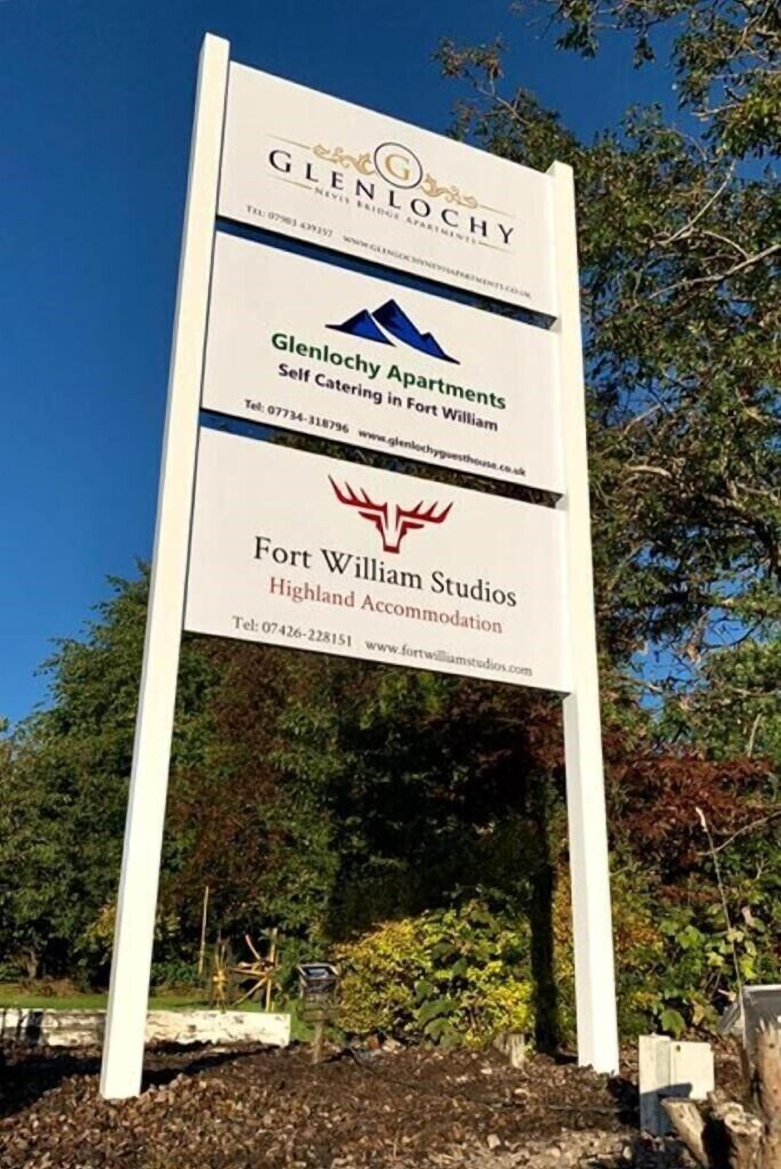A sign for Glenlochy Apartments and Highland Accommodation.