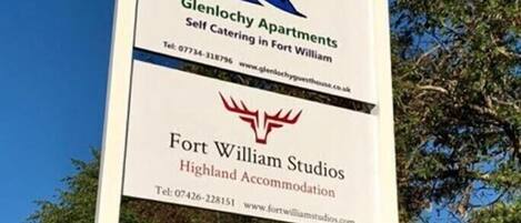 A sign for Glenlochy Apartments and Highland Accommodation.
