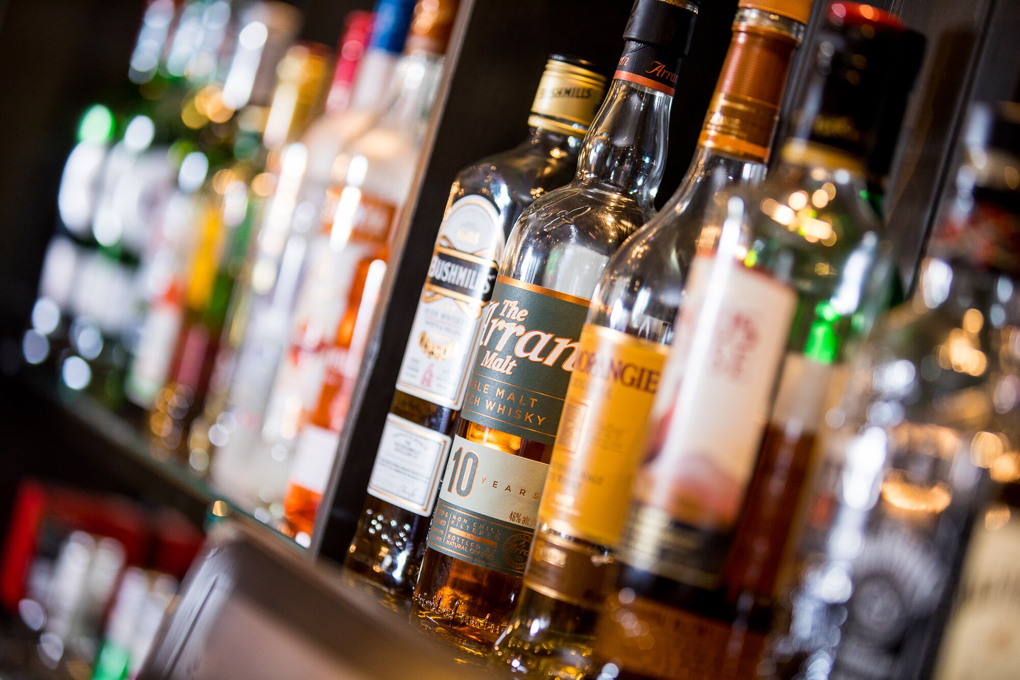 A bar with various bottles of whiskey and other spirits.