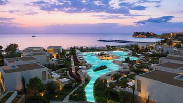 A resort with a swimming pool, beachfront views, and modern architecture.