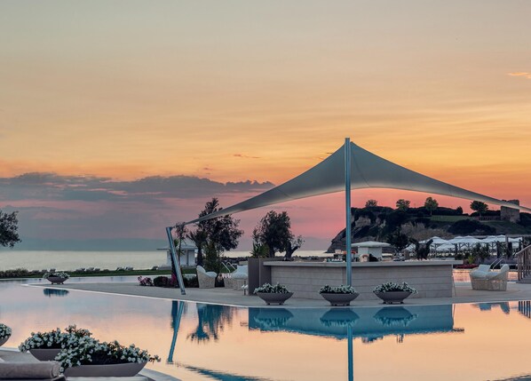 Indoor pool, outdoor pool, pool umbrellas, pool loungers