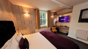 A hotel room with a bed, a TV, a chair, and a window. - The Forest Lodge (Mansfield)