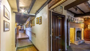 A hallway with wooden flooring, a staircase, and a door labeled "The Cellar of New York." - The Forest Lodge (Mansfield)