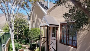 A garden with a patio, a bird bath, and a small gazebo.